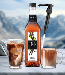 1883 Maison Routin vanilla syrup pump in action for easy dispensing.