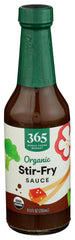 365 by Whole Foods Market organic stir-fry sauce bottle being poured for quick weeknight dinners.