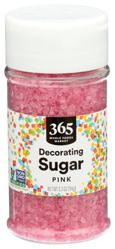 365 by Whole Foods Pink Decorating Sugar in a 3.3 oz jar adds festive sparkle to baked goods.