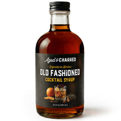 Aged and Charred Old Fashioned Mix bottle pour for a bar-quality home cocktail.