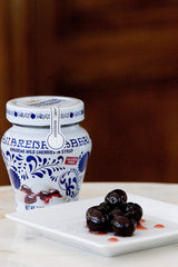 Close-up of Amarena Fabbri cherries atop gelato, an elegant topping.