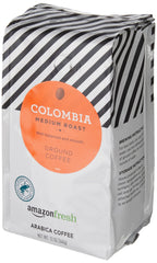 Amazon Fresh Colombia coffee beans close-up shows 100% Arabica quality.