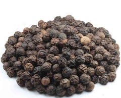 Whole Tellicherry peppercorns pour from Amazon Grocery bag over dishes.