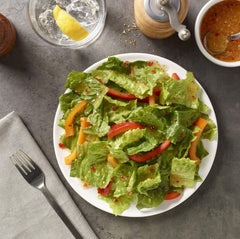Amazon Saver Italian Dressing on a colorful salad plate with greens