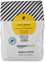 Amazon Fresh Just Bright light roast grounds brewing steam hinting at crisp flavor.