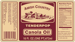 Amish Country Popcorn oil being poured over a bowl to elevate popcorn flavor.
