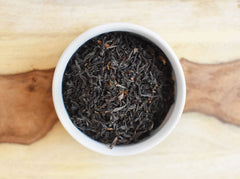 Anthony's Organic English Breakfast tea steeping in cup releases warm aroma.