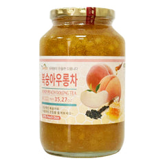 APEXY Honey Peach Oolong Tea bottle closeup showing real fruit infusion for a refreshing drink.