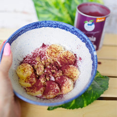 Pouring Aronia Original powder into a smoothie for daily use.