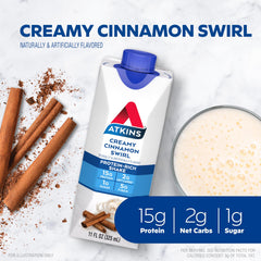 A glass of Atkins Creamy Cinnamon Swirl shake beside a cup of coffee