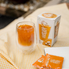 Authentic Thai Iced Tea brew step two with ice and milk for serving.