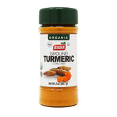 Badia Organic Turmeric Powder bottle pouring, adds vibrant color to curries and rice.