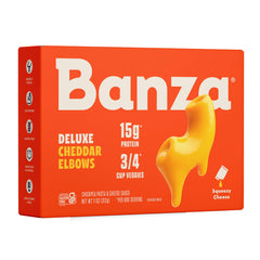 Banza Deluxe elbows mac and cheese with creamy cheddar sauce being poured for a quick, protein-rich weeknight dinner.