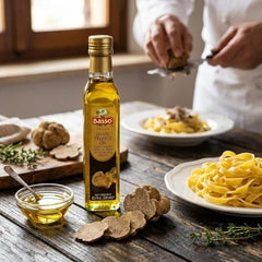 Pouring BASSO 1904 White Truffle Oil over a dish to enhance flavor.
