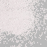 Bayep white edible pearls 2mm bottle adds a refined finishing touch to elegant desserts.
