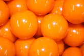 Bayside Candy orange gumballs 1-inch closeup, perfect for bright candy displays.