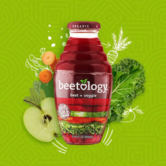 Beetology glass of vibrant juice on a table highlights color and hydration.