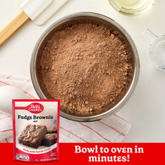 Brownie batter being stirred in a mixing bowl with Betty Crocker mix