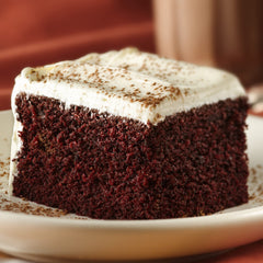Frosting spread on cake using Betty Crocker for quick indulgence.