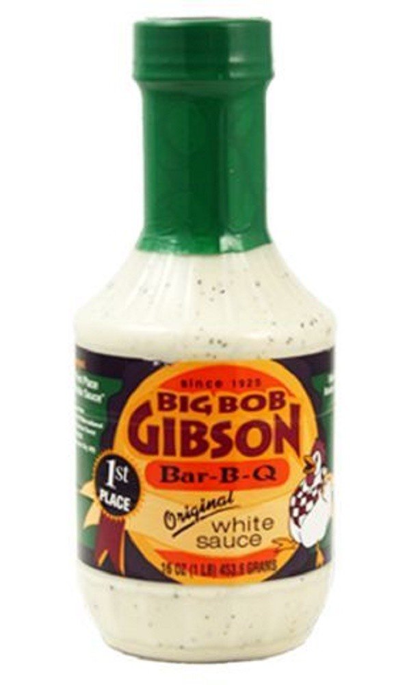 Big Bob Gibson Original White Sauce bottle pouring, ideal for dipping and finishing BBQ.