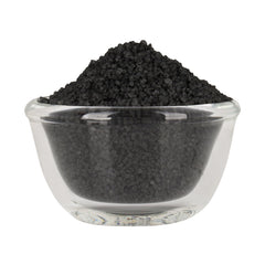 Bless International Black Salt crystal close-up in a spoon for purification rituals