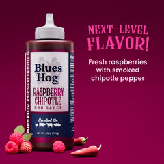 Pouring Blues Hog Raspberry Chipotle BBQ sauce over grilled chicken for a glossy, tangy glaze.