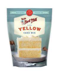 Golden-brown finished cake on a stand with frosting using Bob's mix