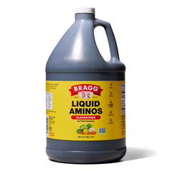 Bragg Liquid Aminos bottle pouring over a sizzling stir-fry for savory flavor