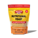 Bragg Original Nutritional Yeast Seasoning bottle adds savory vegan parmesan substitute to dishes.