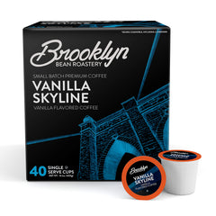 Brooklyn Beans Vanilla Skyline pod on counter beside a Keurig, creamy vanilla aroma.