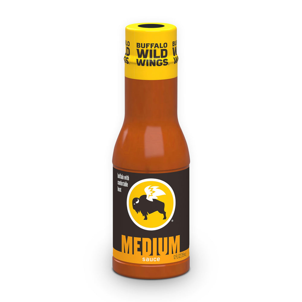 Buffalo Wild Wings Medium Buffalo Sauce bottle pouring over wings for bold flavor