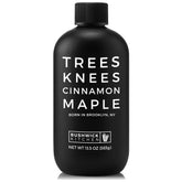 Bushwick Kitchen Trees Knees Cinnamon Maple Syrup bottle on a countertop highlighting the product