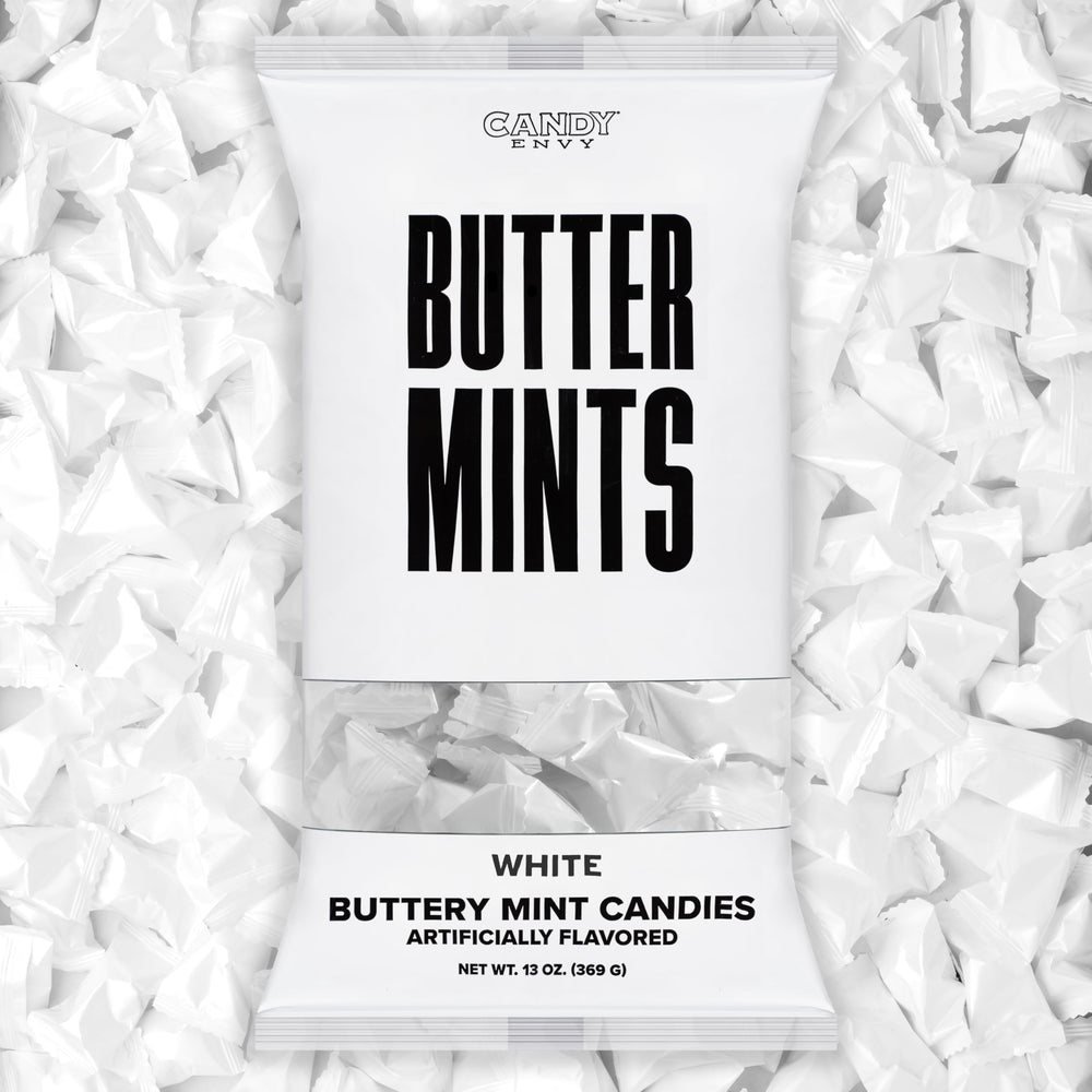 Candy Envy white-wrapped buttermints on a display tray, ideal for weddings.