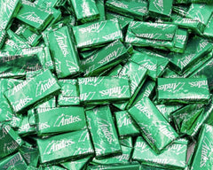 Candy Retailer Crème de Menthe Mints chocolate layers close-up, highlighting smooth texture and mint center.