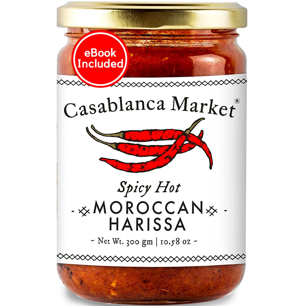 Casablanca Market Harissa bottle being poured for bold Moroccan flavor.