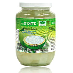 Chaokoh coconut gel in syrup bottle on kitchen counter, ready to sweeten desserts.