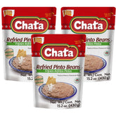 Chata refried pinto beans three-pack on a plate, creamy traditional flavor ready to enjoy.