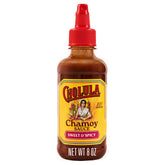 Cholula Chamoy bottle pouring over fruit for a tangy-sweet drizzle