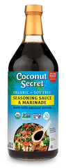 Coconut Secret Coconut Aminos bottle poured over a salad, soy-free flavor option.