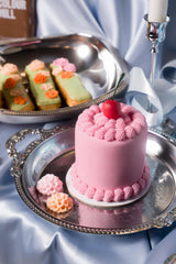 Colour Mill Decorators Dough smooth draped fondant on a cake for polished edges.