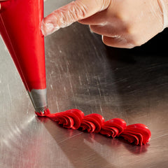 Colour Mill red oil-based coloring blends into ganache for glossy, uniform finish.