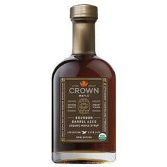 Crown Maple Bourbon Barrel Aged syrup bottle on counter, ideal for pancakes.