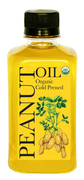 Daana Peanut Oil bottle on counter showcasing organic, cold-pressed quality for healthy cooking.