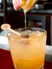 Daniel’s Broiler shaker scene shows small-batch craft mixing for rich flavor.