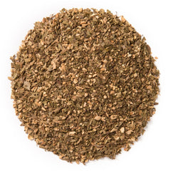 Davidson's Tulsi Ginger Lemon tea cup pouring, showcasing vibrant infusion and inviting aroma.