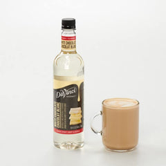 DaVinci Gourmet Classic White Chocolate Syrup pours into a glass for smooth coffee elegance