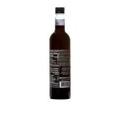 Pouring DaVinci Sugar-Free Blueberry Syrup into coffee for flavor without sugar.