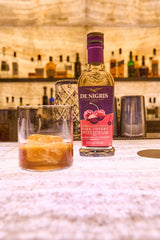 De Nigris bottle pouring to illustrate versatile kitchen staple in recipes.