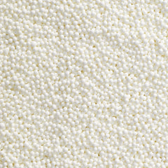 DecoPac white nonpareils on a frosted cake for festive detail
