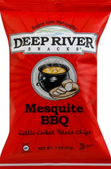 Hands holding Deep River Snacks Mesquite BBQ kettle chips, convenient single-serve option for travel.